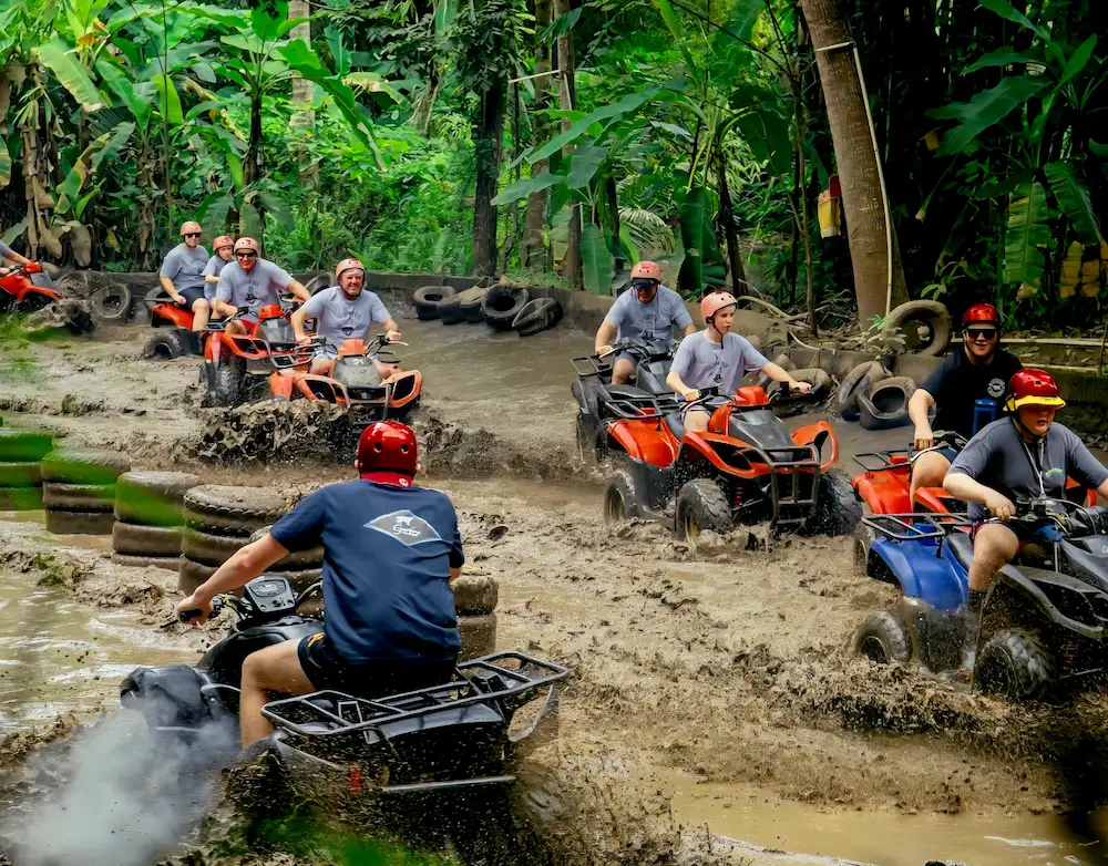 Tourists enjoying a Bali ATV Ubud day trip, riding through jungle tracks and rice fields.