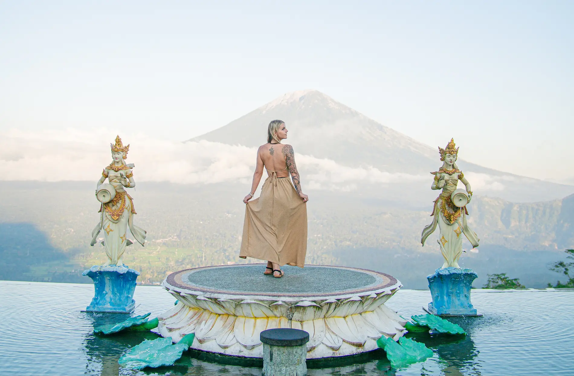 Female traveler at Lempuyang Temple photo spot with Mount Agung in the background – a must-visit Bali Instagram place.