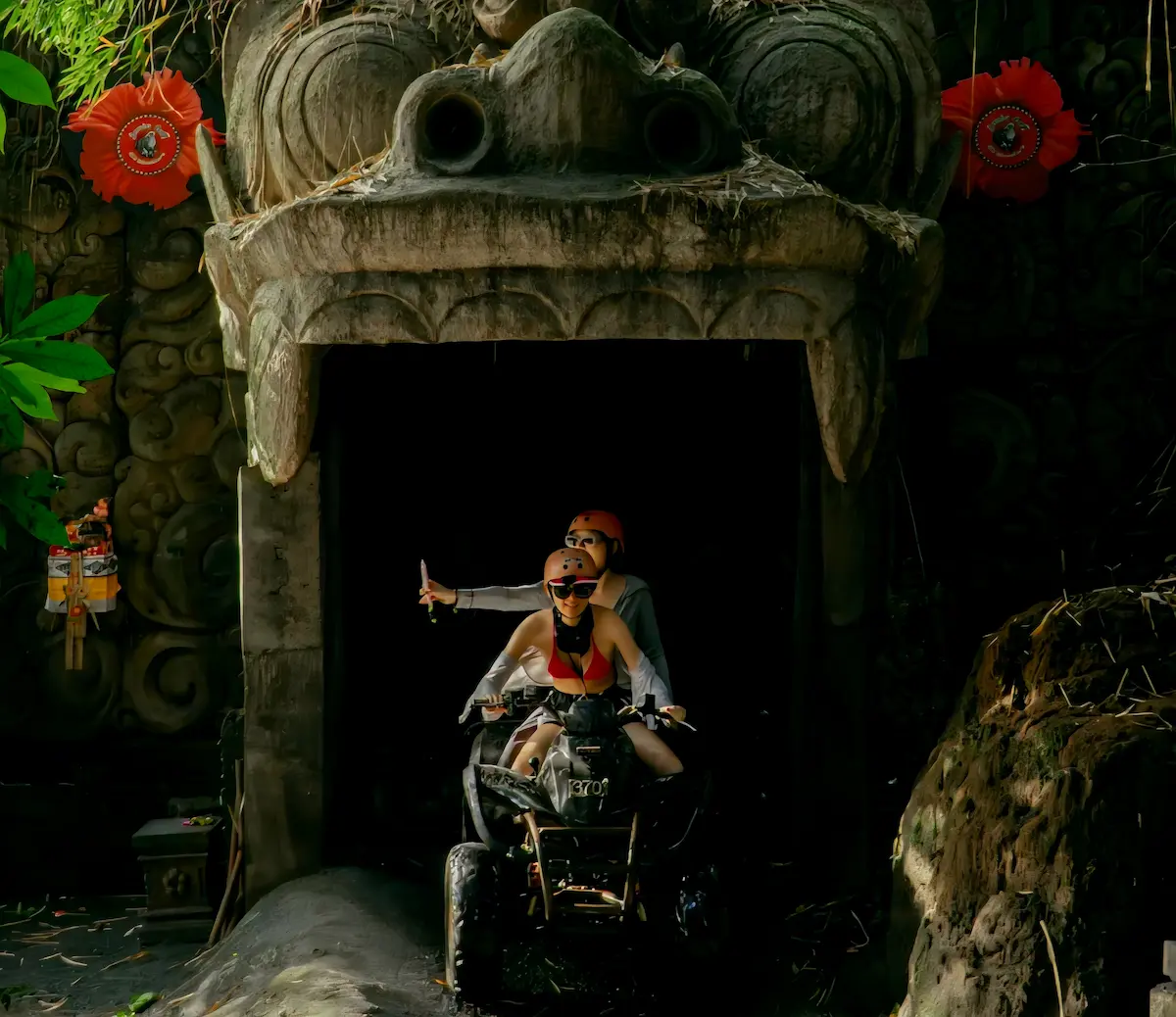 Traveler riding on a Bali Quad Bike Tour through the famous Barong Cave in Ubud.