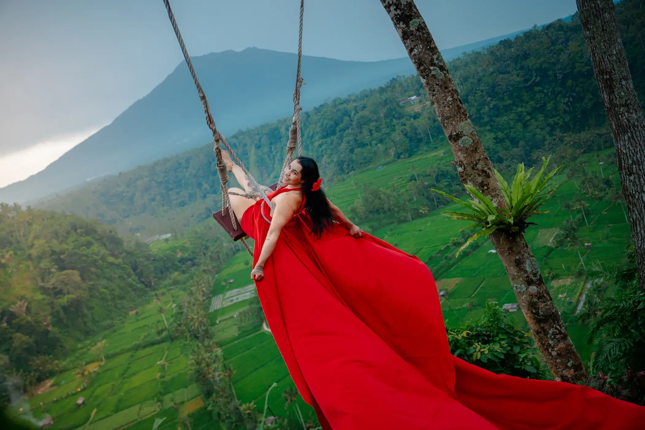 Woman on jungle swing with red flying dress during Bali Instagram Tour experience