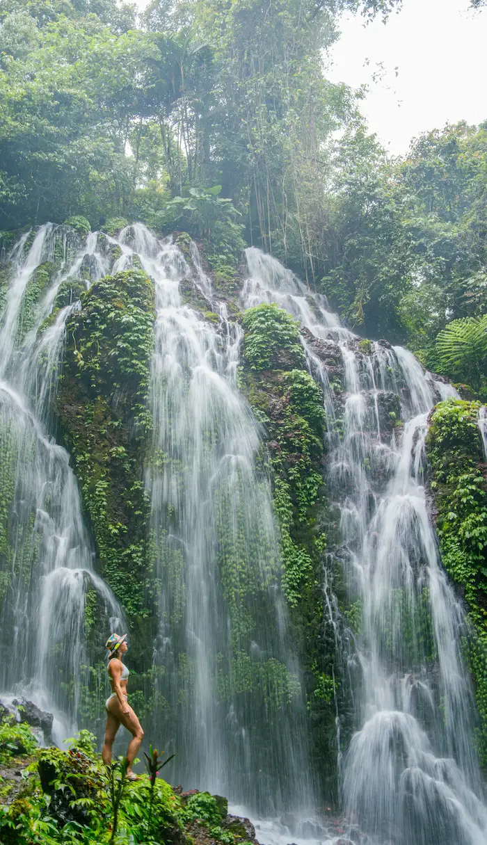 Traveler enjoying Banyuwana Amertha Waterfall, a natural gem on the Bali UNESCO Tour