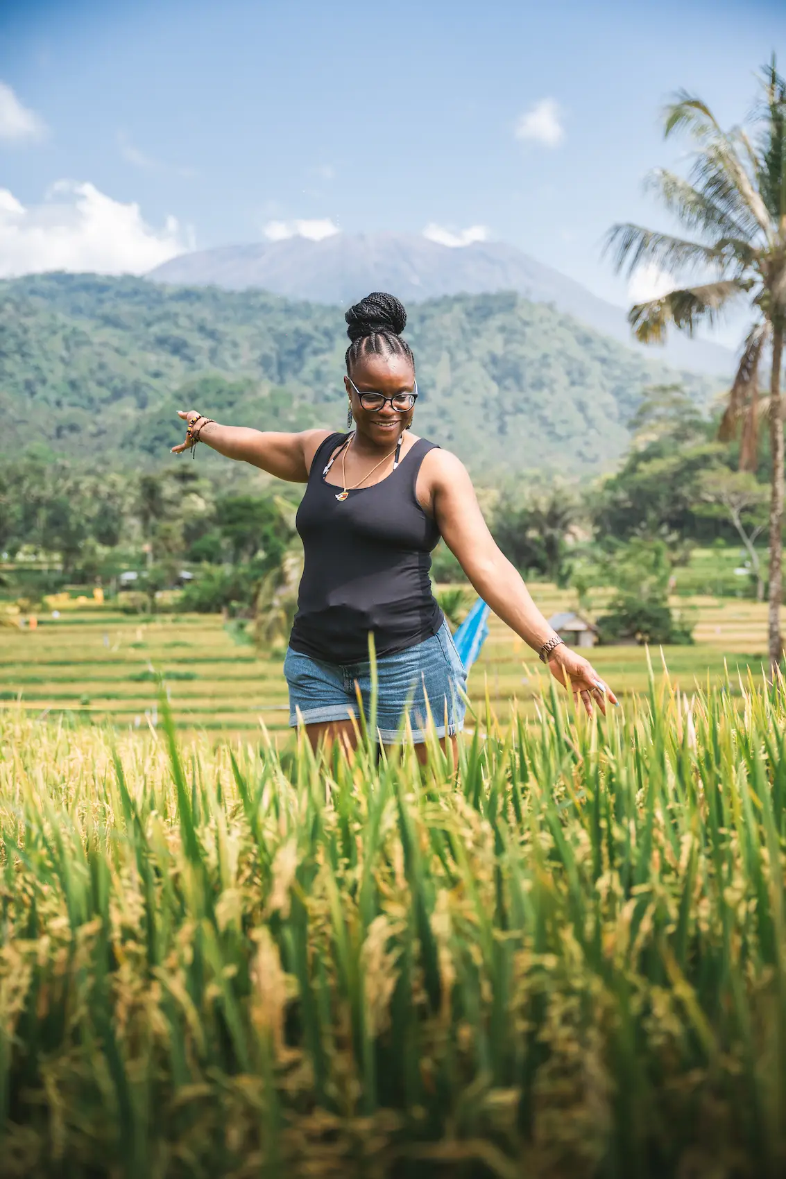 Woman walking through rice terraces, UNESCO World Heritage landscape on the Bali UNESCO Tour