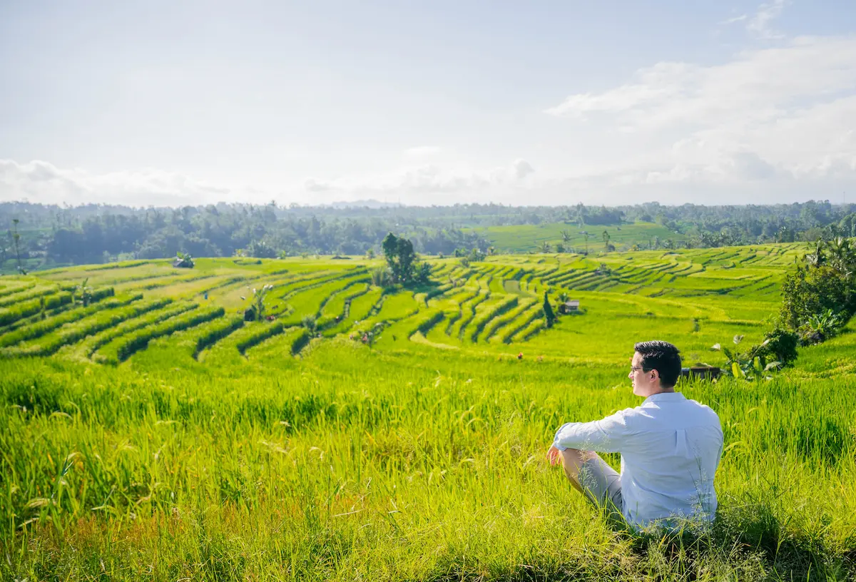 Traveler walking through Jatiluwih Rice Terraces, UNESCO World Heritage site on the Bali UNESCO Tour