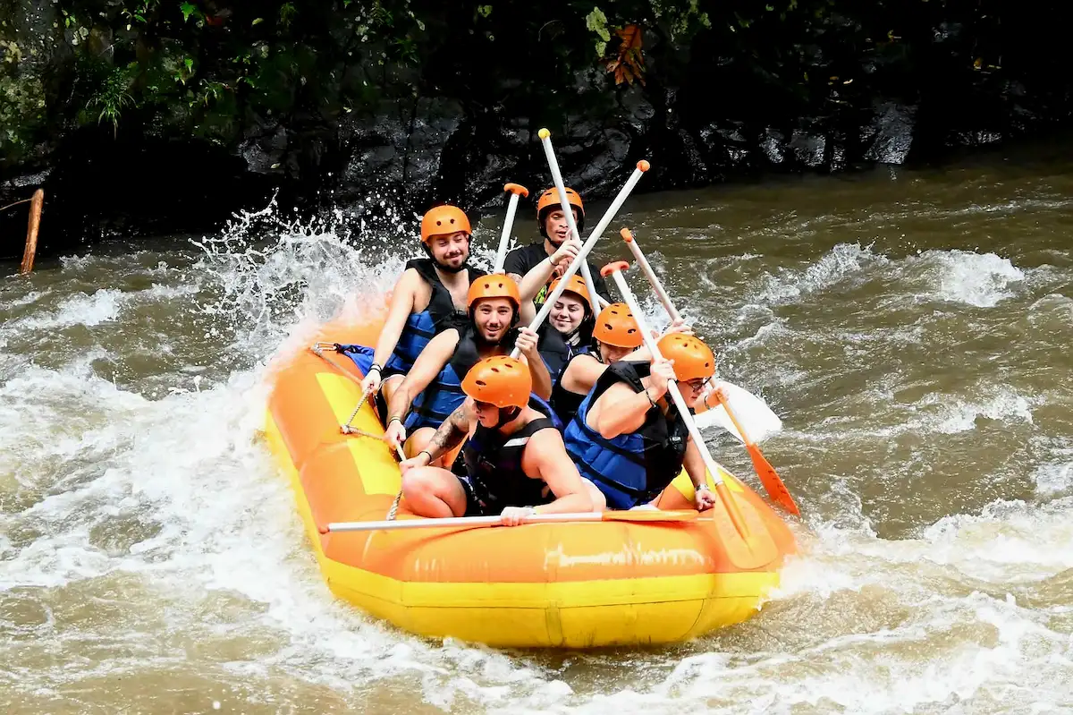 Tourists enjoying a Bali rafting tour on the Ayung River with jungle view