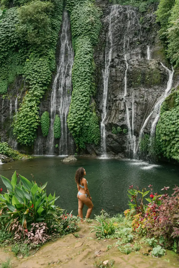 Woman enjoying Banyumala Waterfall on Bali Waterfall Tour