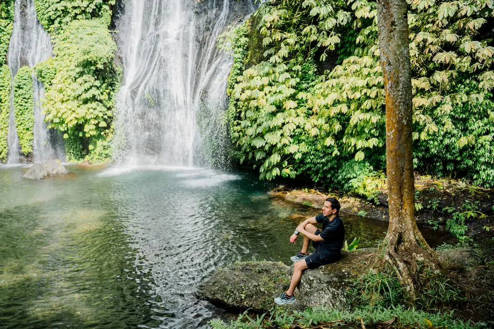 Man enjoying Banyumala Waterfall on private day trips in Bali