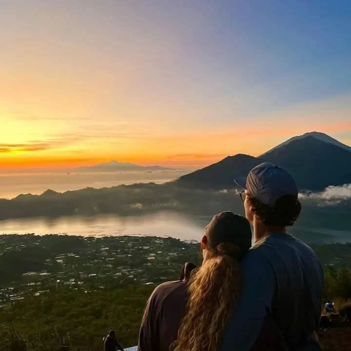 Couple enjoying the sunrise during Batur Sunrise Trekking on Mount Batur, Bali