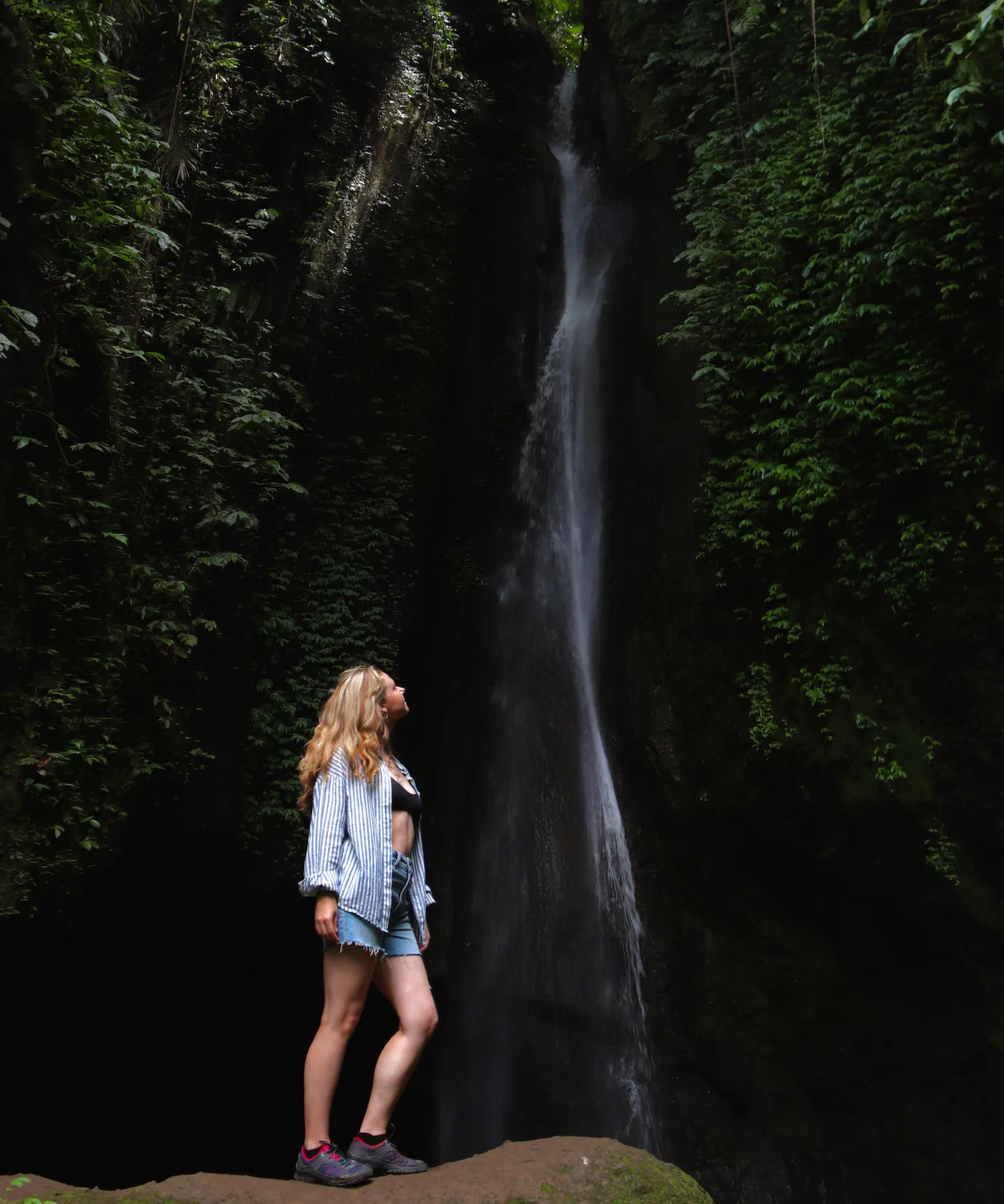 Woman enjoying Leke Leke Waterfall on Bali waterfall Tour