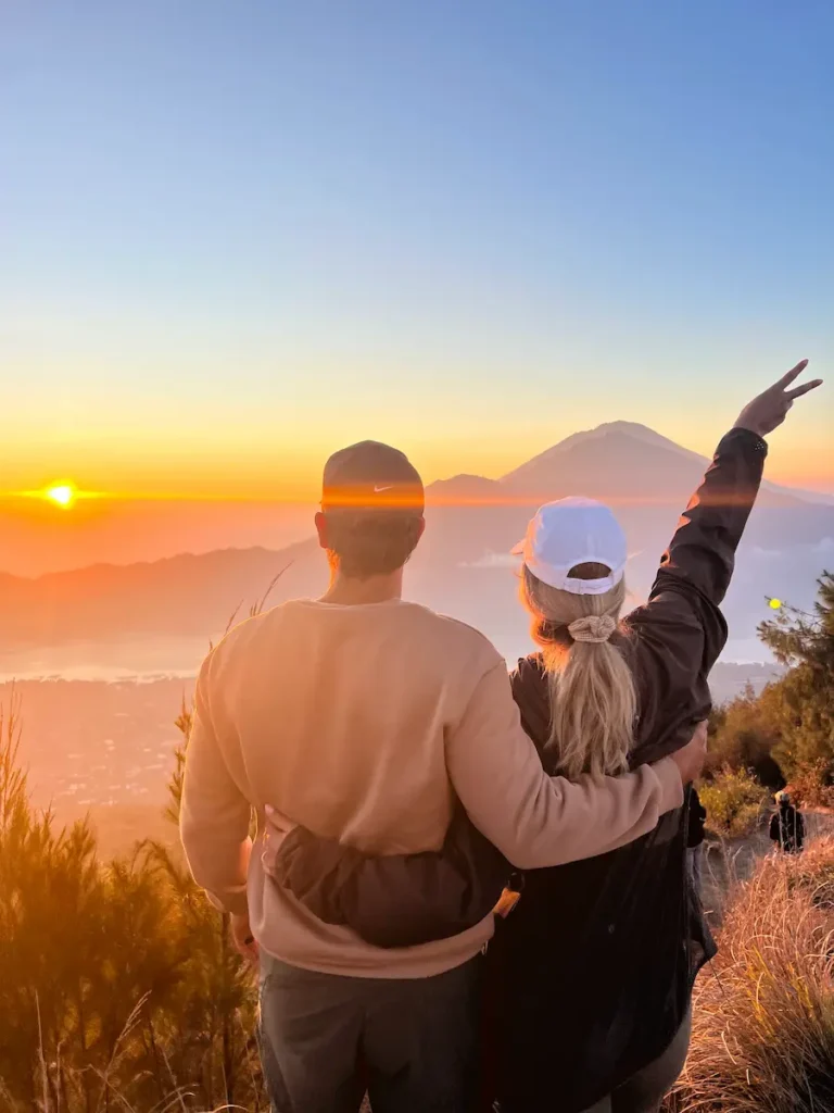 Couple enjoying the sunrise during Batur Sunrise Trekking on Mount Batur, Bali