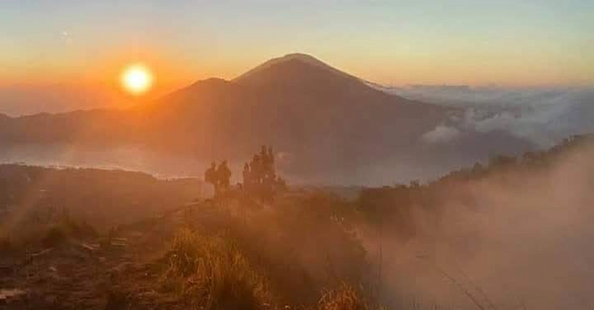 People hiking and enjoying the sunrise during Batur Sunrise Trekking on Mount Batur, Bali