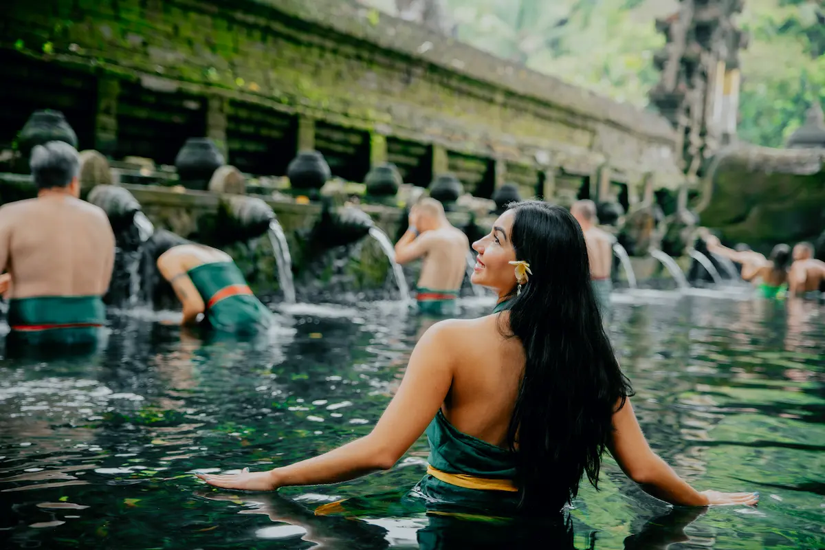 Woman visiting Tirta Empul Temple during an Ubud day trip