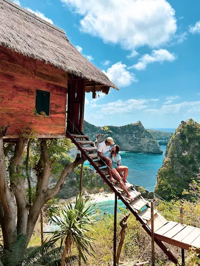 Couple taking photos at the famous Tree House in Nusa Penida during a private Bali day trip