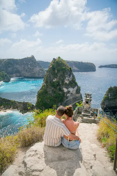 Couple enjoying the view at Diamond Beach Nusa Penida during a Bali day trip